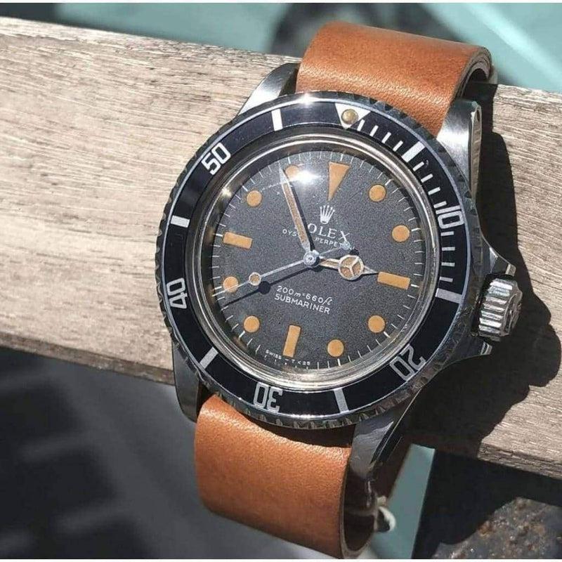 Stylish Military Natural Italian Leather Watch Strap complements a classic Rolex Submariner for timeless elegance.